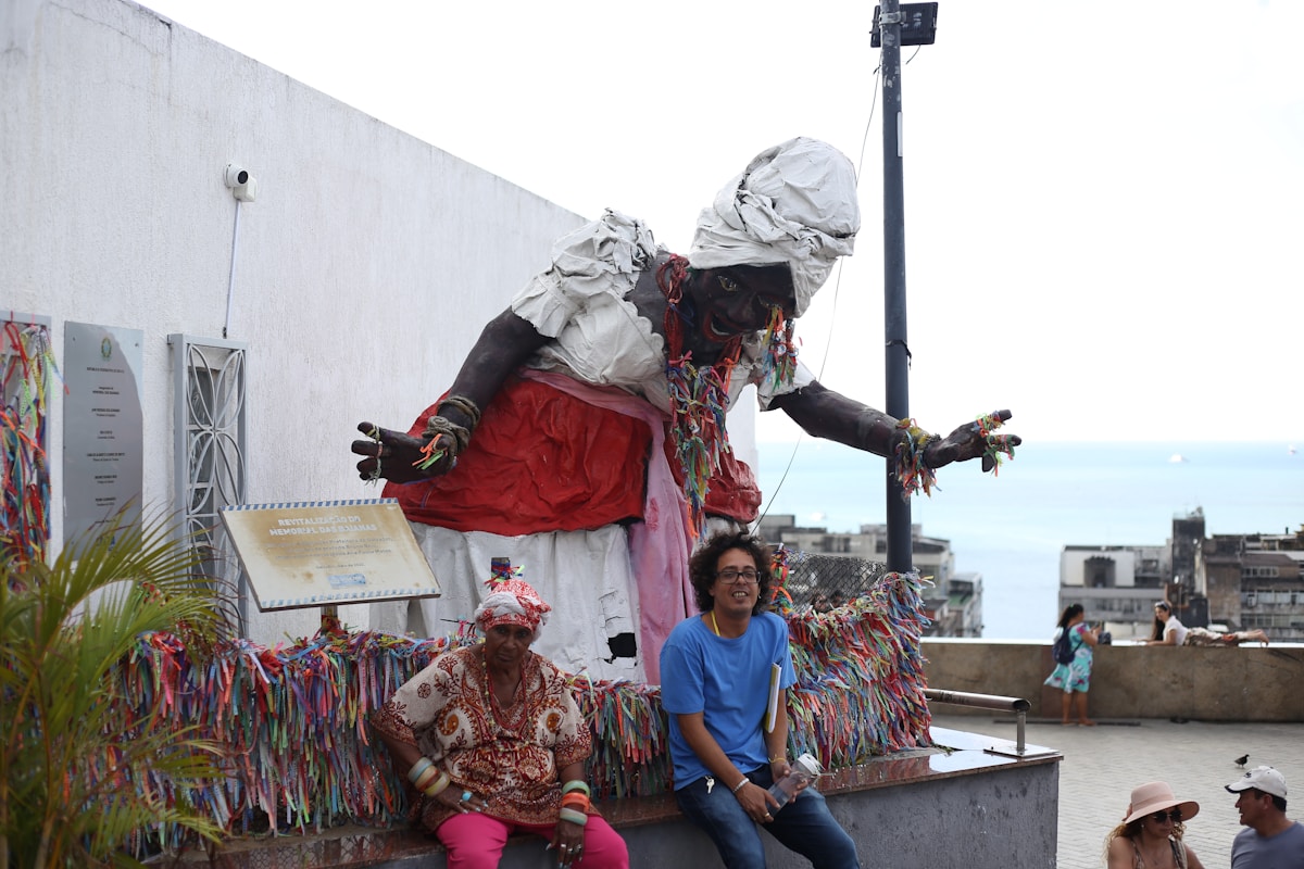 A group of people sitting on top of a statue