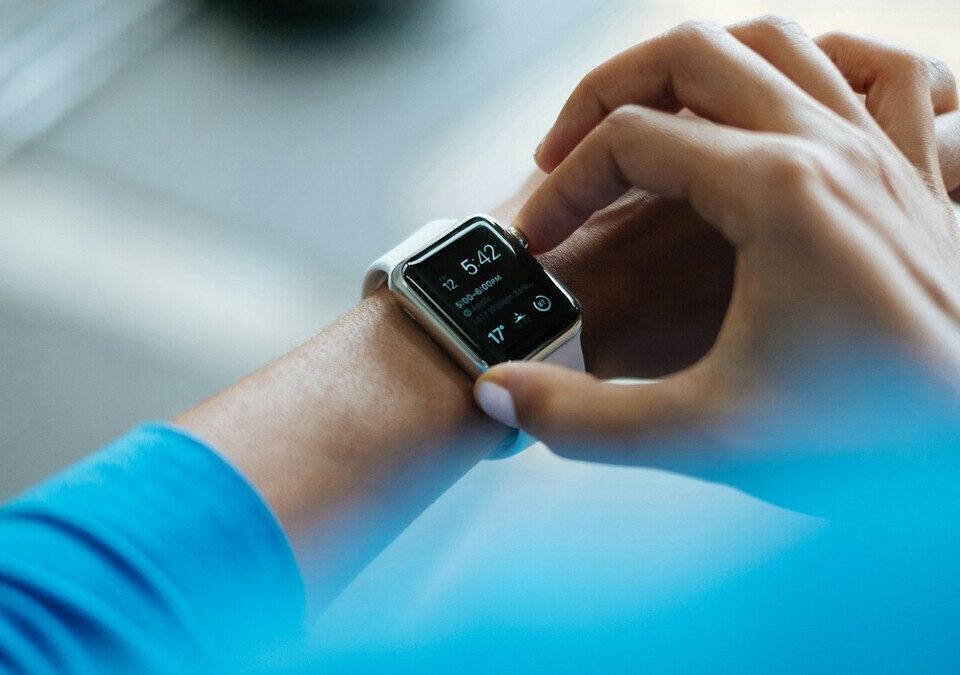 Mão tocando um smartwatch no pulso